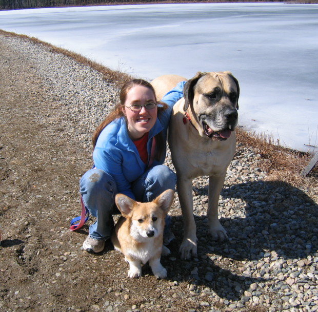 A girl sitting on the ground with charlie and buster