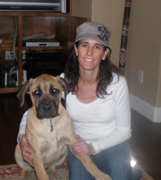 A woman with a grey hat with a dog named Josie