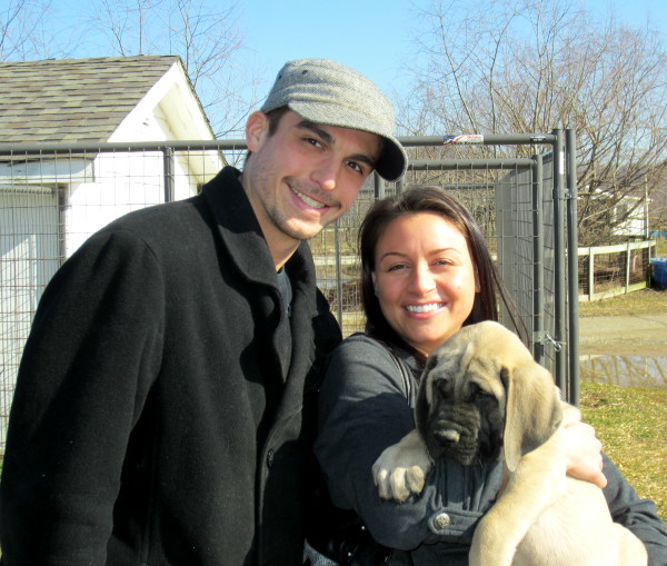 A couple wearing coats posing with Maximus