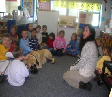 A class of children and a teacher with a dog