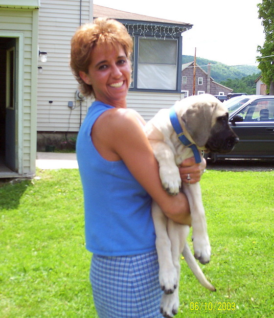 A woman holding a dog in her arms.